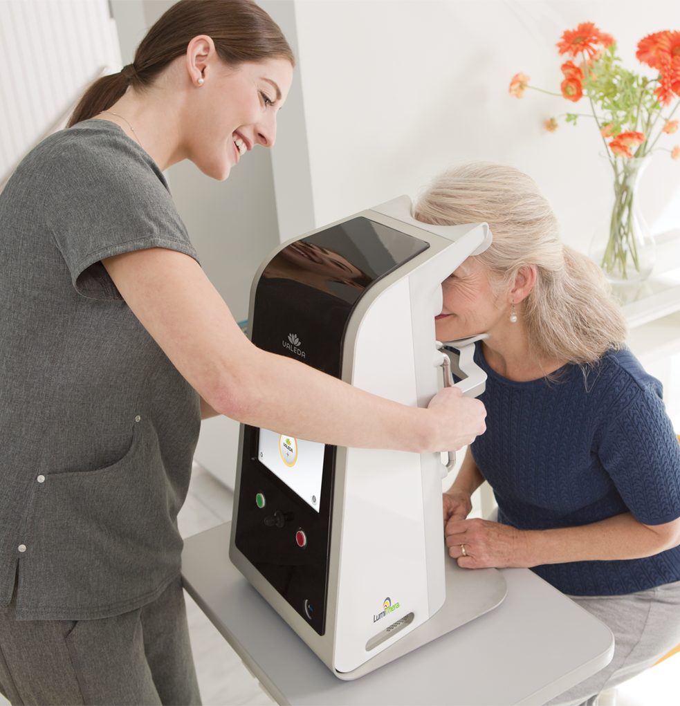 a mature lady sat at the Valeda Light Therapy Machine receiving treatment for Dry Age Related Macular Degeneration. Treatment for Dry AMD.