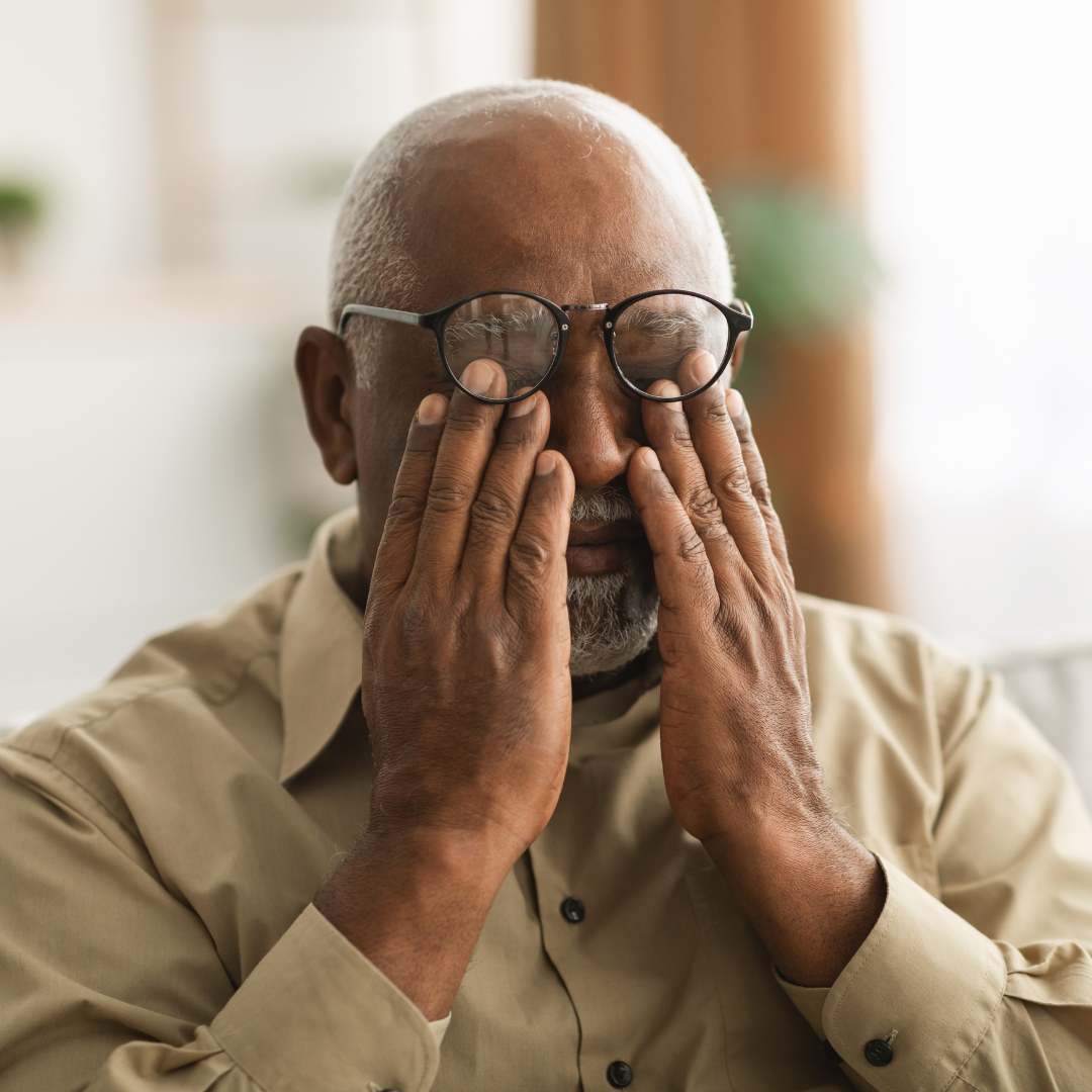 Man with glasses on forehead rubbing eyes, glaucoma. Alcohol and Eyesight