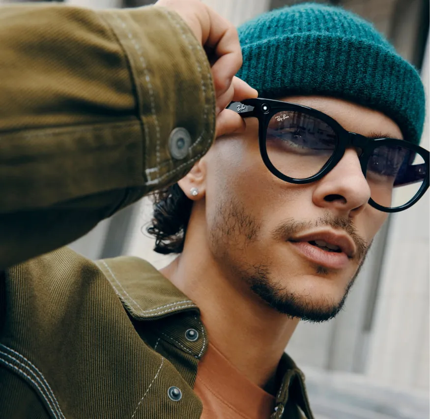 Man wearing a green beanie hate and Ray Ban Meta Smart Glasses