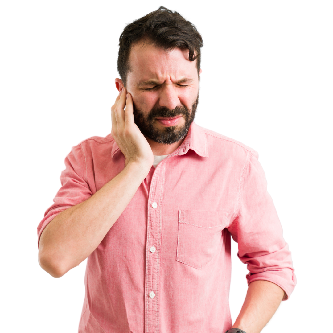 Man with brown hair and beard, wearing a pink shirt, holding his ear in pain. Tinnitus.