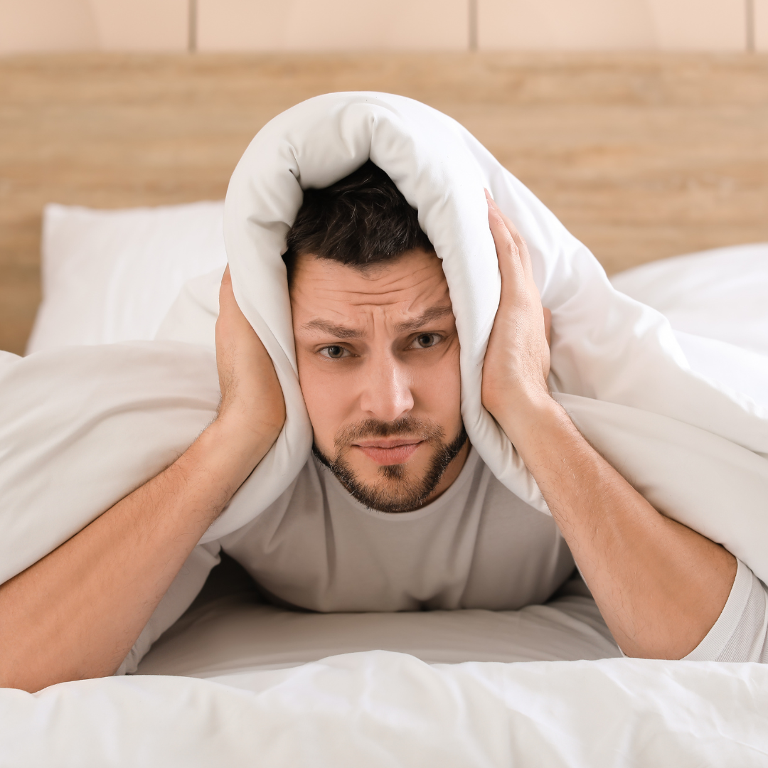 Man struggling to get to sleep because of Tinnitus